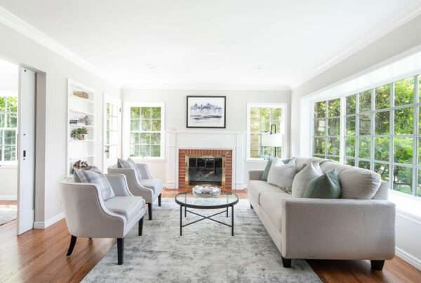 Image displays the interior of a living room in a Magnolia home, where the walls, ceilings, and trims have been freshly painted. The uniform color scheme creates a cohesive and serene atmosphere, harmonizing with the room's furnishings and decor. The painted trims outline the architectural features, adding definition to the space. The lighting in the image beautifully illuminates the painted surfaces, showcasing the quality of the paintwork. The overall view provides an inviting glimpse into this stylish Magnolia home.