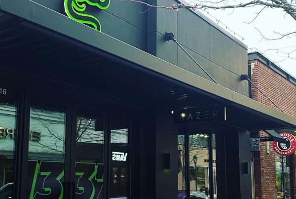 Exterior view of a commercial store front, featuring a freshly painted stucco finish in sleek tricorn black SW 6258, enhancing its modern architectural design.