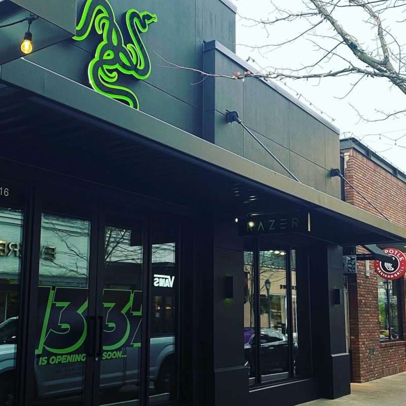 Exterior view of a commercial store front, featuring a freshly painted stucco finish in sleek tricorn black SW 6258, enhancing its modern architectural design.