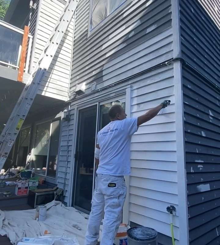 Applying multiple coats for durable exterior paint.