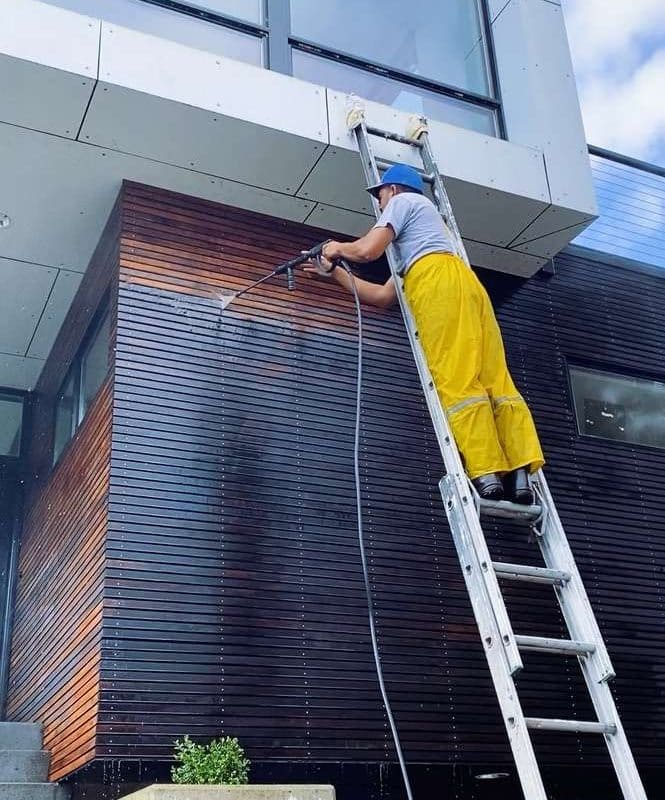 Seattle painter cleaning house exterior before painting.