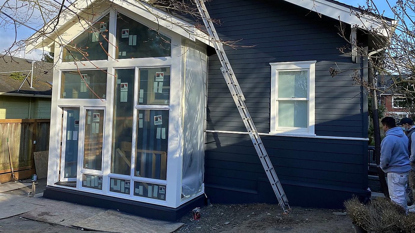 House with deep navy siding and crisp white trim